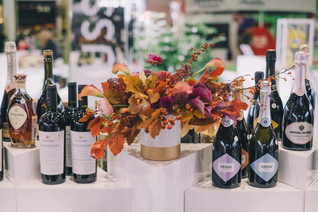 Fall flower arrangement with orange beige and purple autumn flowers in a vase for wine stand at CIIE 2018