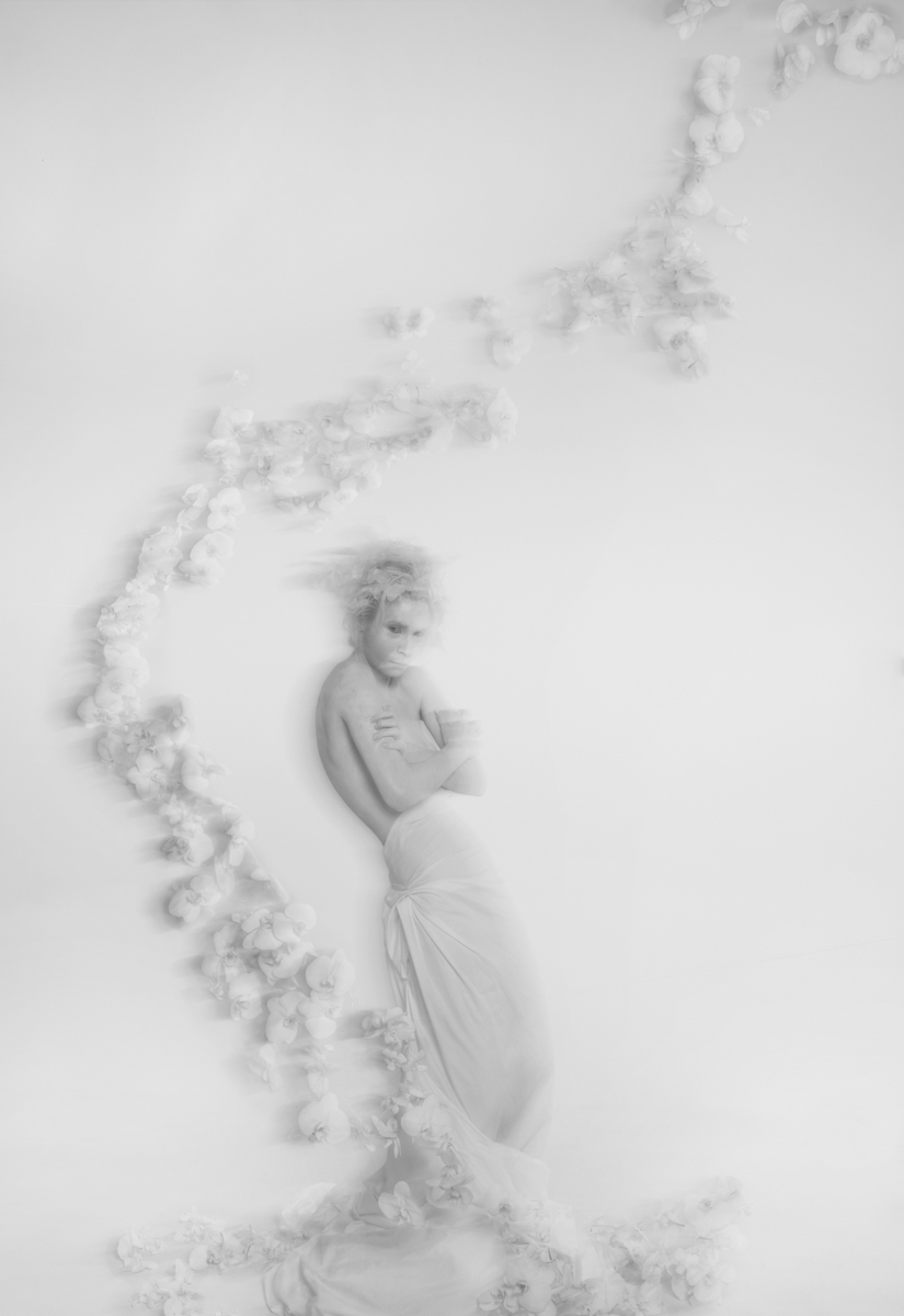 Flower installation with white floating orchids around a girl painted in white body black and white photo by Florist and set designer in Shanghai China Daria Bokova