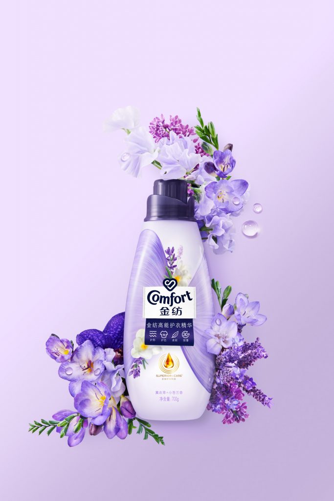Conditioner purple bottle surrounded by purple flowers lavender freesia